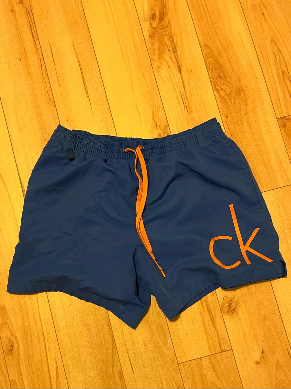 Calvin Klein Blue Swim Trunks with Orange Accents